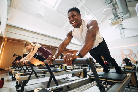 Harry Aikines-Aryeetey using Reformer equipment in the new studio at Hitchin Swimming and Fitness Centre