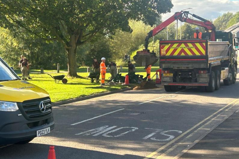 Sand being unloaded from a lorry on a road